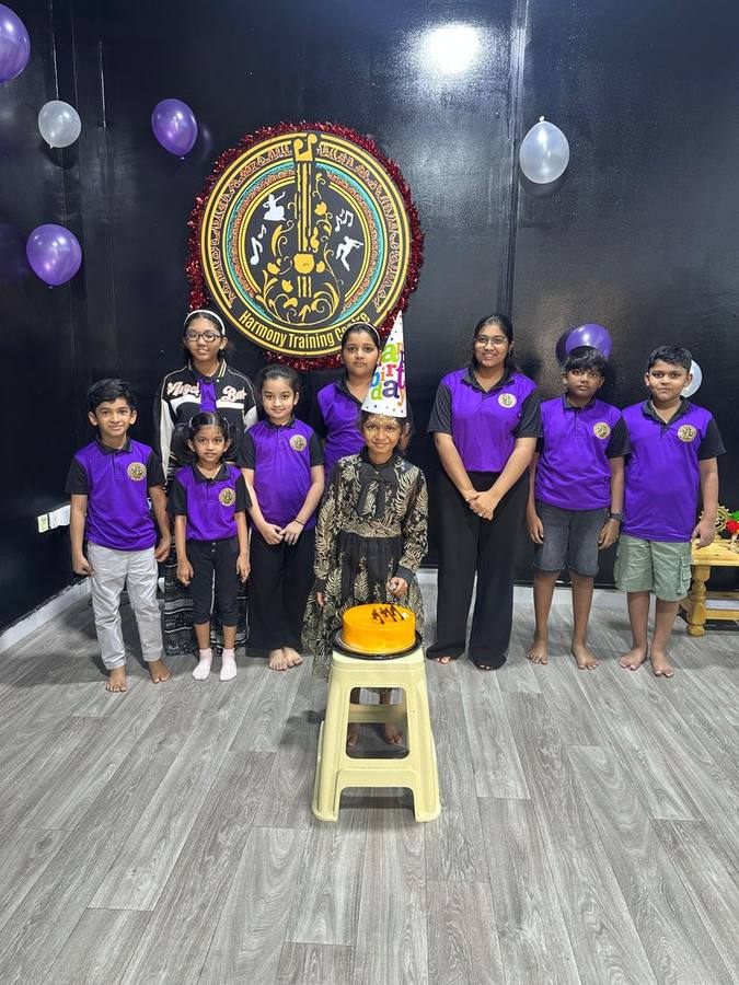 Students and instructor celebrating a birthday at the studio with a cake