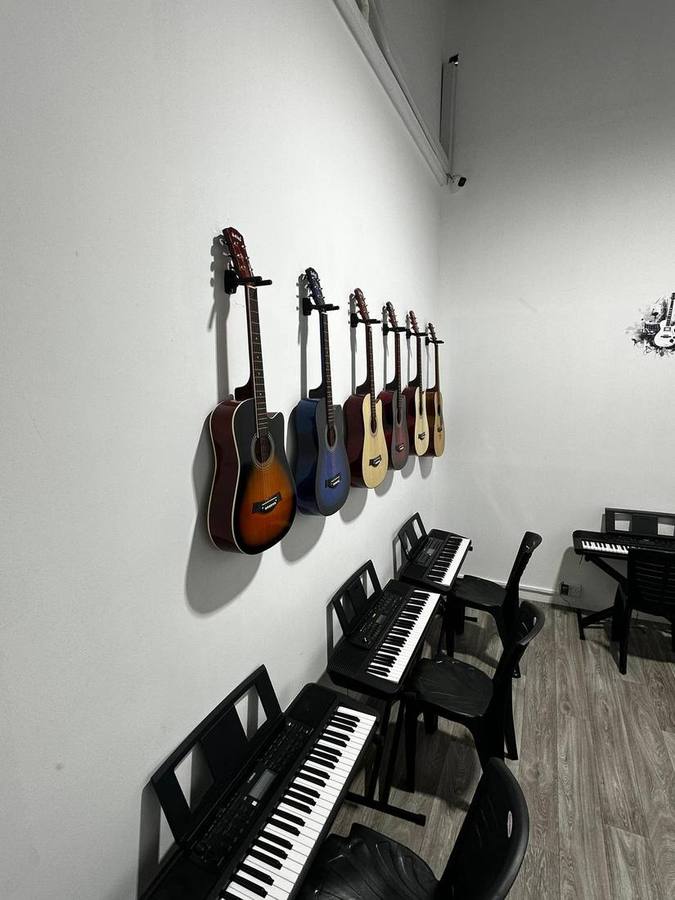 Acoustic guitars mounted on the wall at Harmony Music Training Centre